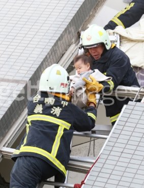 A baby is rescued from a collapsed apartment.