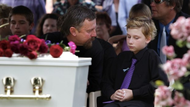 Jordan's father John and the brother he saved, Blake, at the teenager's funeral.