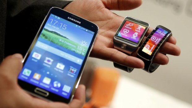Changes on the cards: Samsung's current Galaxy S5 smartphone (left), Gear 2 smart watch and Gear Fit fitness band.