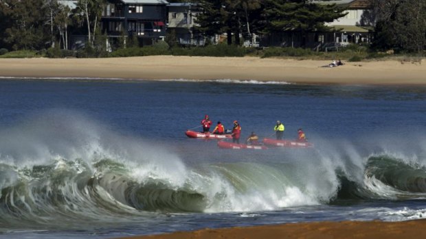 "Cannons going off": waves break on Pearl Beach as rescuers search.