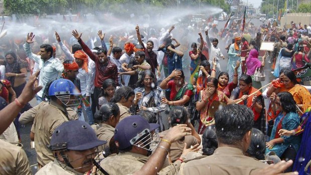 Outrage: Police use a water cannon to stop demonstrators from moving towards the office of Chief Minister Akhilesh Yadav.