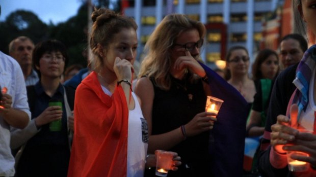 French students Marie Mailys Blasco, left, and Peyro-Saint-Paul join a large crowd in King George Square in solidarity with the French people following the Paris attacks.