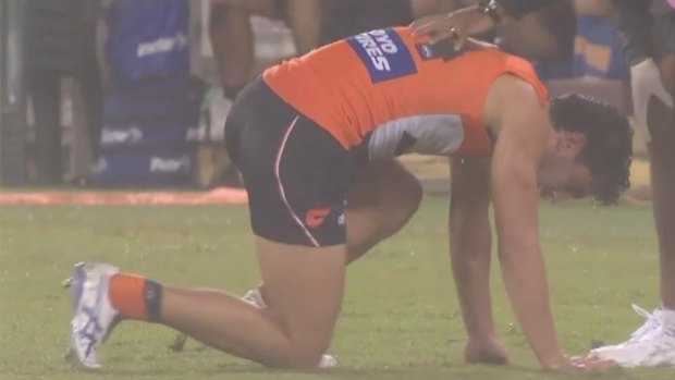 Taranto struggles to his feet after the heavy collision and is taken from the field.
