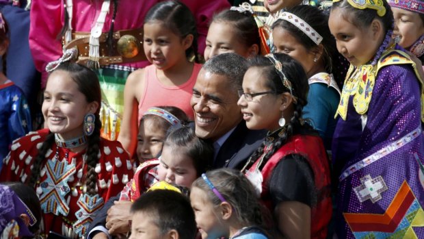President Obama poses with Native America dancers.