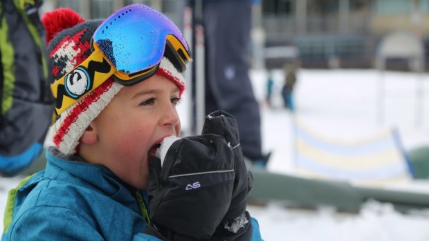 A kid at Perisher Blue appreciates the snow after 15 centimetres fell overnight.