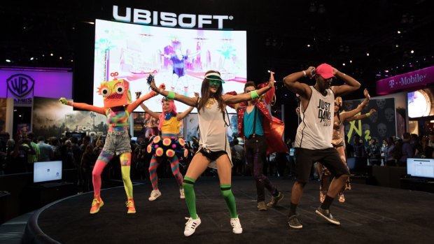 Performers promoting Just Dance 2017 at game publisher Ubisoft's booth.