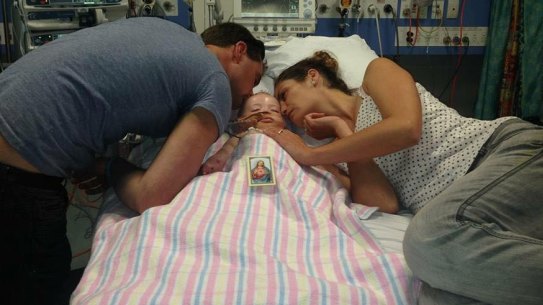 Grant and Naomi Day with Kyran at Sydney Children's Hospital. 