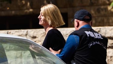 60 Minutes reporter Tara Brown escorted from court in Beirut on Monday.