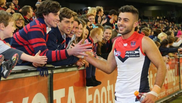 Christian Salem celebrates with Demons supporters after the game.