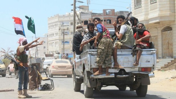 Fighters loyal to Yemen's Saudi-backed President Abedrabbo Mansour Hadi patrol a street in Aden on Tuesday.