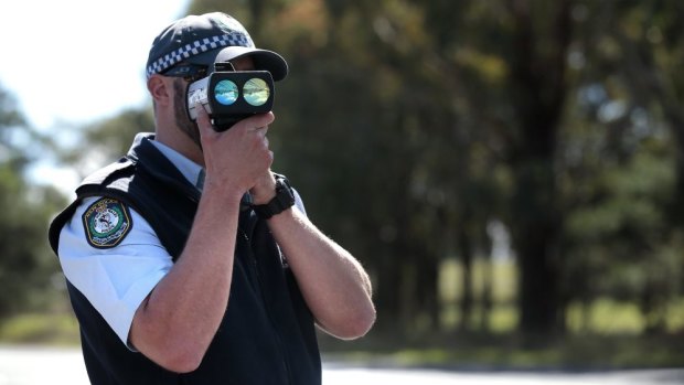 A NSW Police officer checks speed during the launch of Operation Crossroads last year.