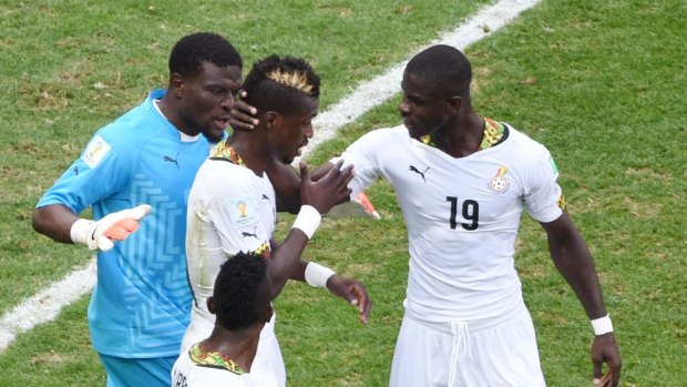 It's okay ... Ghana's defender John Boye (centre) is consoled by teammates after scoring an own goal against Portugal. He was filmed kissing the $US3 million sent by Ghana's president before the game.