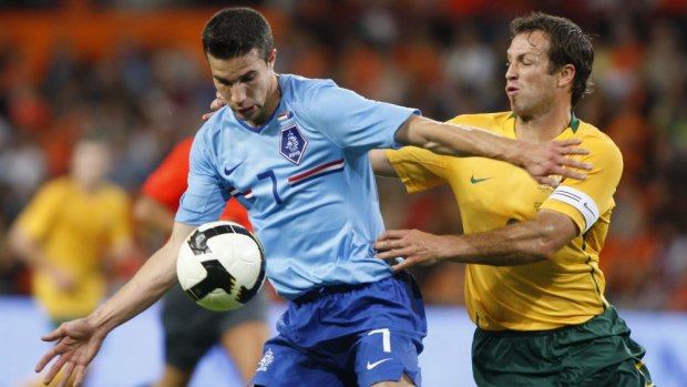 Robin van Persie and Lucas Neill fight for possession when Australia played the Netherlands in 2008.