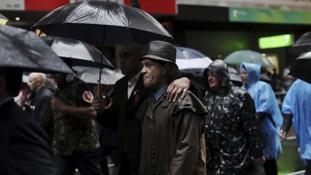 Veterans march in a wet Anzac Day parade.
