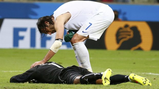 Greece’s Giorgios Samaras consoles Ivory Coast’s Boubacar Barry after scoring a penalty.