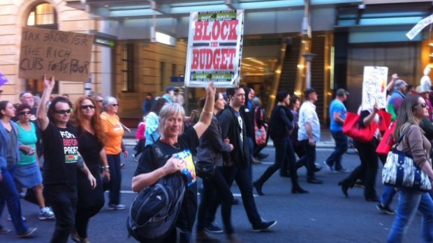People take to the streets of Brisbane to protest over the Federal Budget.