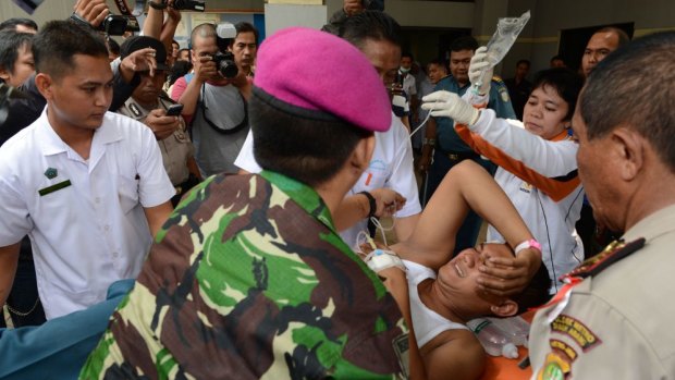 Emergency: A man injured in the blast is brought to a navy hospital in Jakarta.