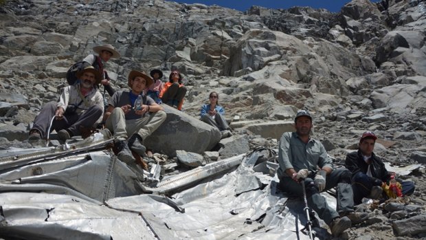 Chilean mountaineers pose  on what they say is the wreckage of a plane that crashed in the Andes 54 years ago.