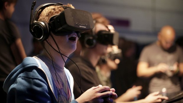Gamers test the Oculus Rift headset at the Eurogamer Expo in 2013.