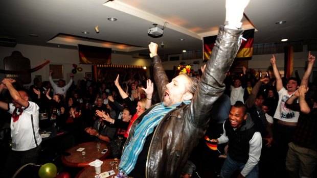 Fans at the Harmonie German club react with delight as Germany scores.