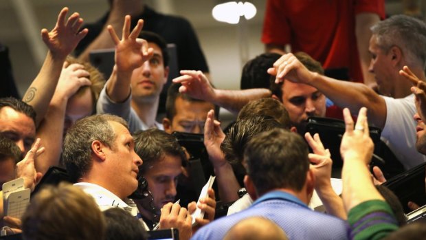 Traders signal offers in the Standard & Poor's 500 stock index options pit at the Chicago Board Options Exchange .