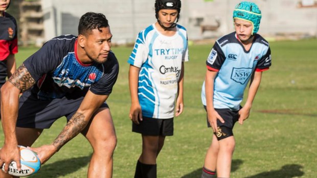 Israel Folau trains with school kids at the Barker College Rugby Fields.