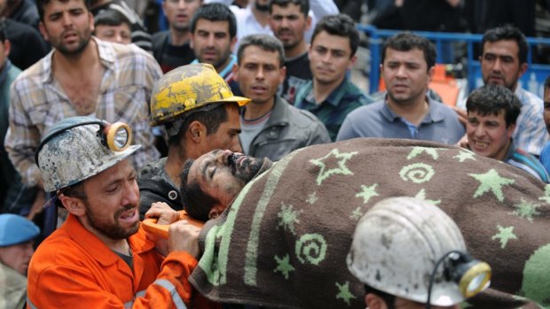Rescue workers carry the body of a miner outside the coal mine in Soma, Turkey.