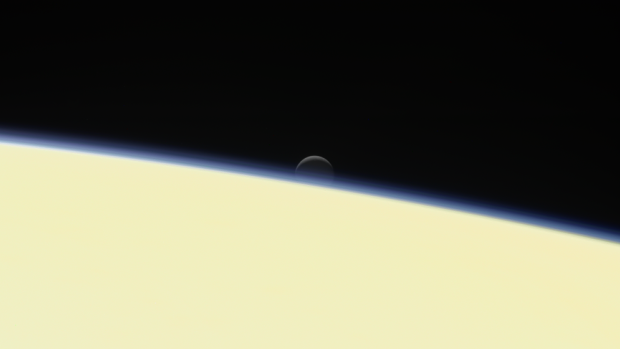The moon Enceladus sets behind Saturn. This is one of the last images Cassini took.