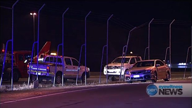A woman crashed her car through a fence and onto the Brisbane Airport tarmac on Tuesday night.