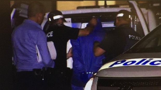 The alleged Tingalpa shooter, who police said was armed with a loaded shotgun, surrenders himself.