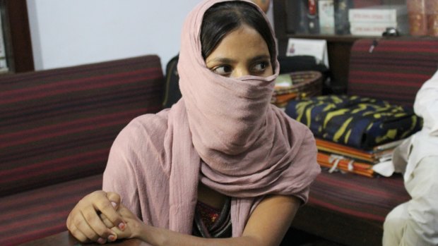 Bitiya, who agreed to be photographed with her face covered, in her village.