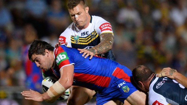 Tariq Sims gets to grips with Kade Snowden on Monday night.