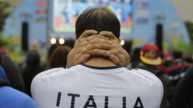 Another upset ... An Italy football fan watches his team lose against Costa Rica.