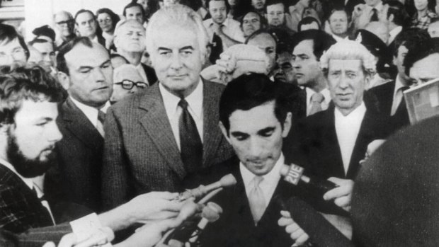 Gough Whitlam stands behind David Smith, the secretary to the Governor-General, as he reads the proclamation dissolving parliament following the dismissal of the Whitlam government.