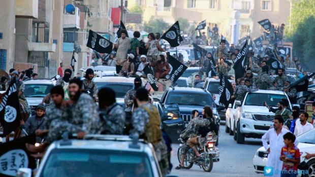 Islamic State fighters parade in Raqqa, Syria.