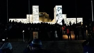 Tens of thousands stand in silence at the Dawn Service in Canberra