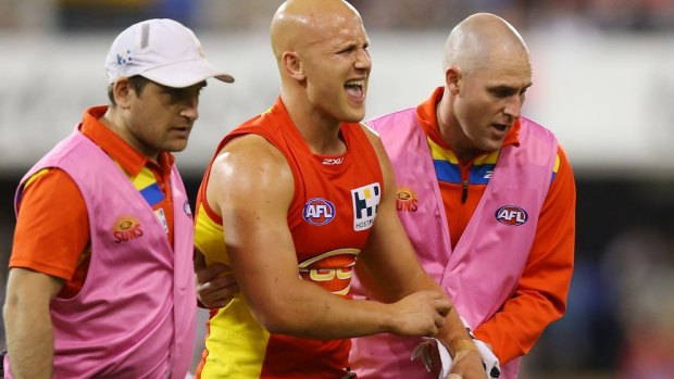 Gary Ablett leaves the field in pain in the third quarter of the game against Collingwood.