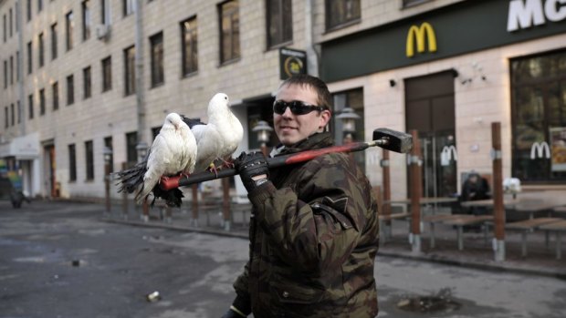 Hammer and doves: A fragile truce held in central Kiev early Saturday following concessions by the government of Viktor Yanukovych.