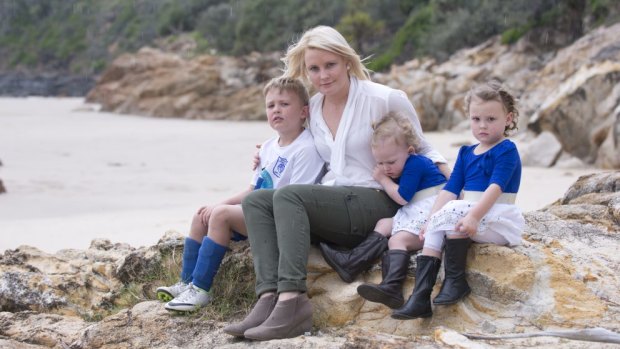Emma Clark with her children Jake, 5 ,Sienna, 4, and Olivia, 2, at Coolum Beach.
