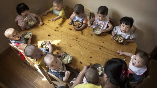 Chinese children tuck in at a foster care centre in Beijing.