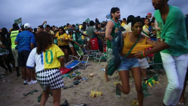 Chaos breaks out on Copacabana Beach after Germany scored its fifth goal against Brazil. 