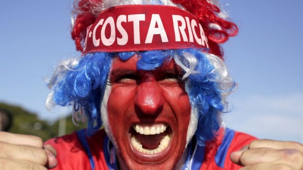 Plenty to cheer about ... A supporter celebrates Costa Rica's classification at the top of Group D following the draw against England.