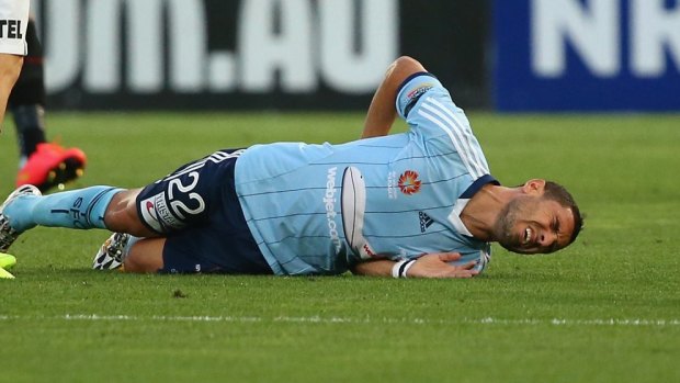 Pain for Sydney FC: Ali Abbas lies injured on the ground.