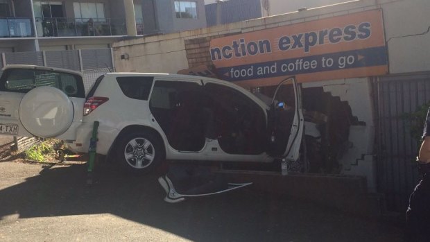An SUV crashes into a Bowen Hills shop, trapping the driver and causing structural damage to the business.