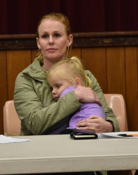 Mrs Golding, pictured holding her daughter Georgia, says her family "won't be able to live" if a proposed 43 per cent pay cut goes ahead for Griffin Coal workers. 