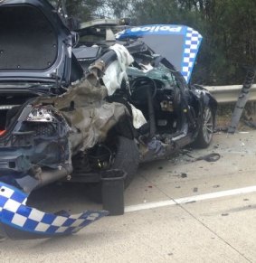 The police car was parked on the side of the M1 when a truck crashed into the vehicle.