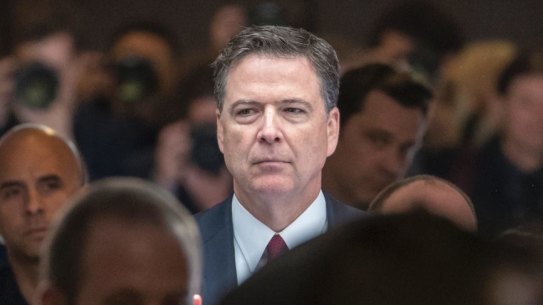Former FBI director James Comey walks through a corridor on the way to a secure room to continue his testimony to the Senate Select Committee on Intelligence.