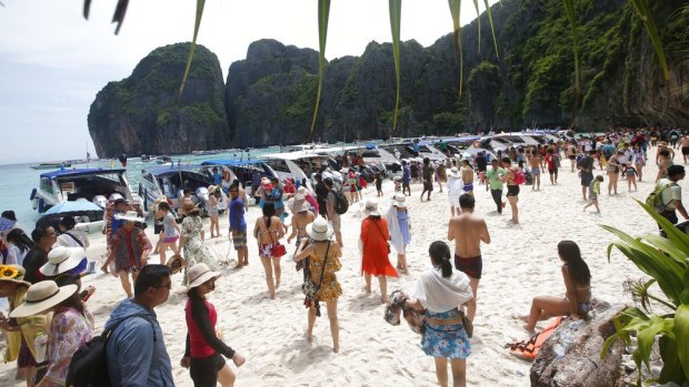 Tourists enjoy the beach on Maya Bay, Phi Phi Leh island in Krabi province, Thailand.