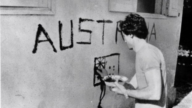 Greg Shackleton paints "Australia" on a shop wall in Balibo in East Timor in 1975. He and five other journalists were killed while covering Indonesia's invasion.