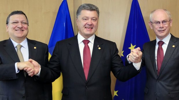 Ukraine's President Petro Poroshenko, centre, poses with European Commission President Jose Manuel Barroso, left, and European Council President Herman Van Rompuy, right.